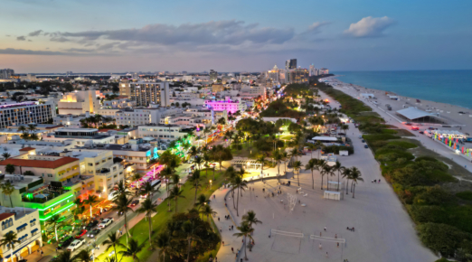 Aerial view of Miami with Ocean Drive at night. Top view of South Miami with Ocean Drive at evening. Panoramic Miami evening coastline with Ocean Drive. Miami shoreline on Ocean Drive.