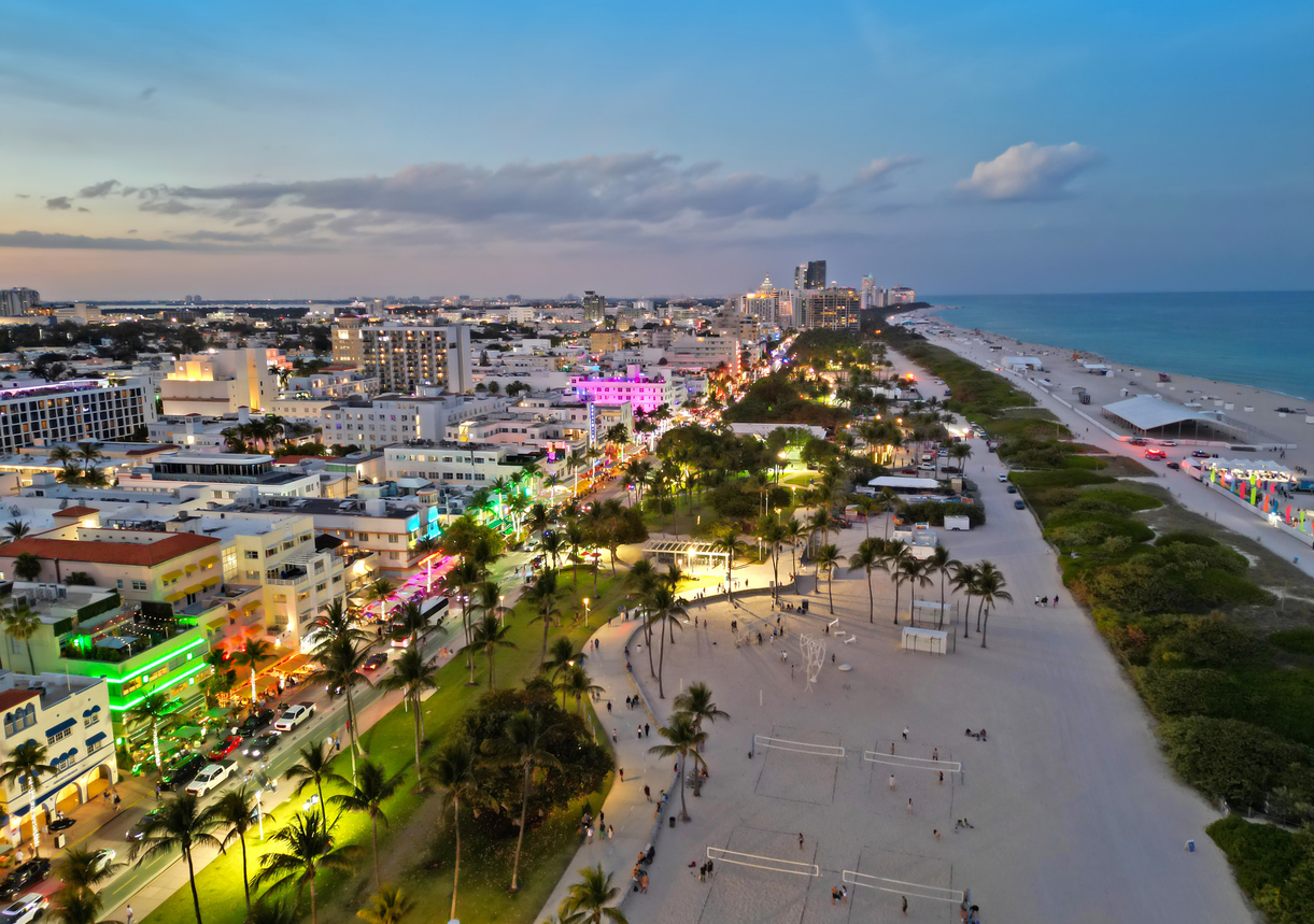 Aerial view of Miami with Ocean Drive at night. Top view of South Miami with Ocean Drive at evening. Panoramic Miami evening coastline with Ocean Drive. Miami shoreline on Ocean Drive.